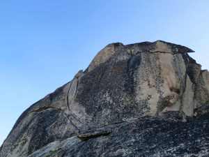The big twin Bear Hug cracks are visible left of center, followed by a ramp to the right, belaying just before rounding the corner.